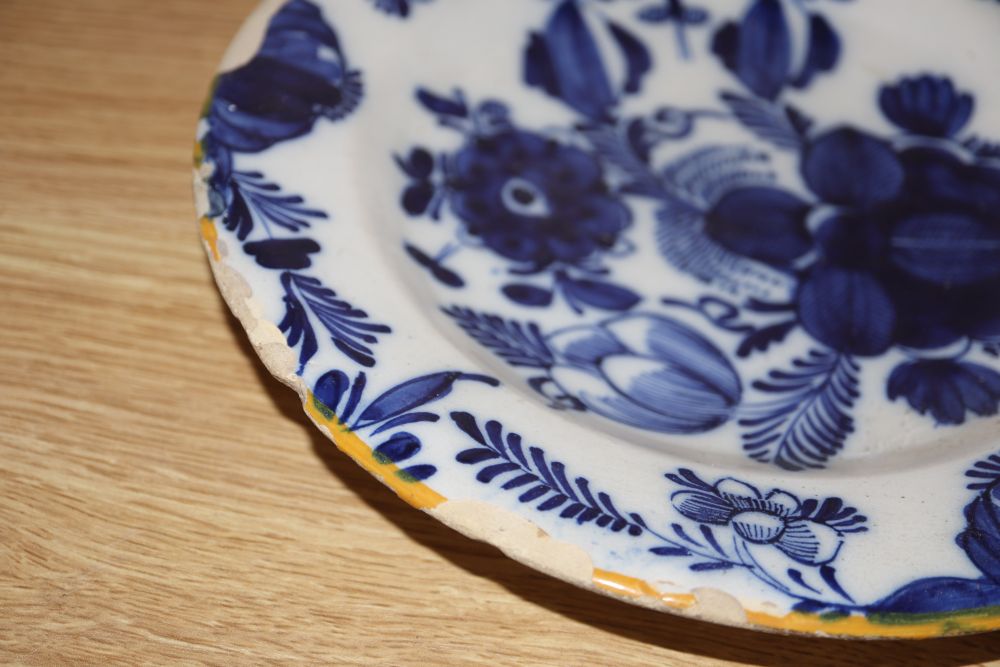 A collection of five 18th century Delft dishes, largest diameter 23cm